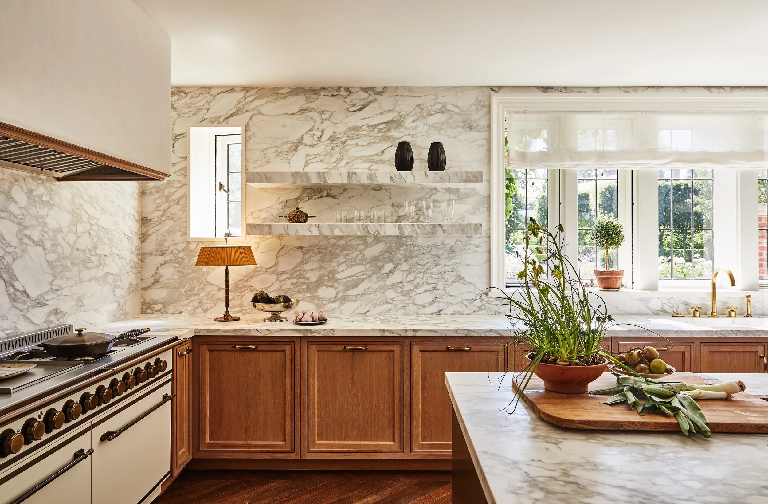 marble cladded kitchen with wood cabinets