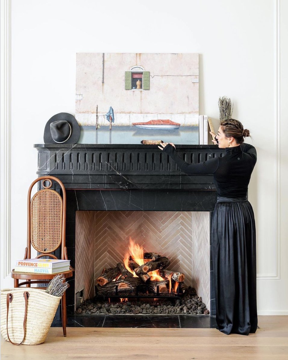 classic elegant fireplace in black marble and herringbone
